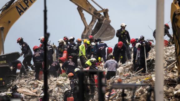 Crews work at the site of the collapsed building on July 6.