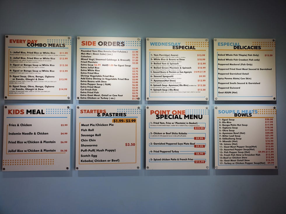 The menu at Point One African Cuisine is displayed on the wall next to the front counter where customers order.