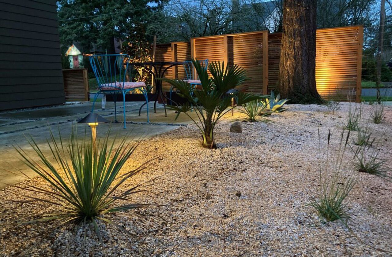 A modern house in Beaumont has a Southwest desert landscape by designed by Garden Stories. Yuccas, agaves a and a specimen Waggy Palm thrive in a minimalist environment that includes buff-colored aggregate and privacy-providing cedar screens like those seen at Portland Japanese Garden. Calvin Chen